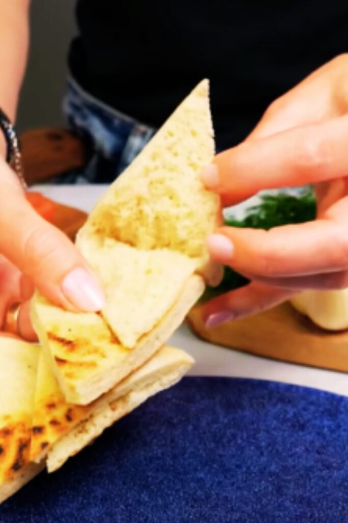 Golden chicken souvlaki cooking on grill grates with perfect char marks